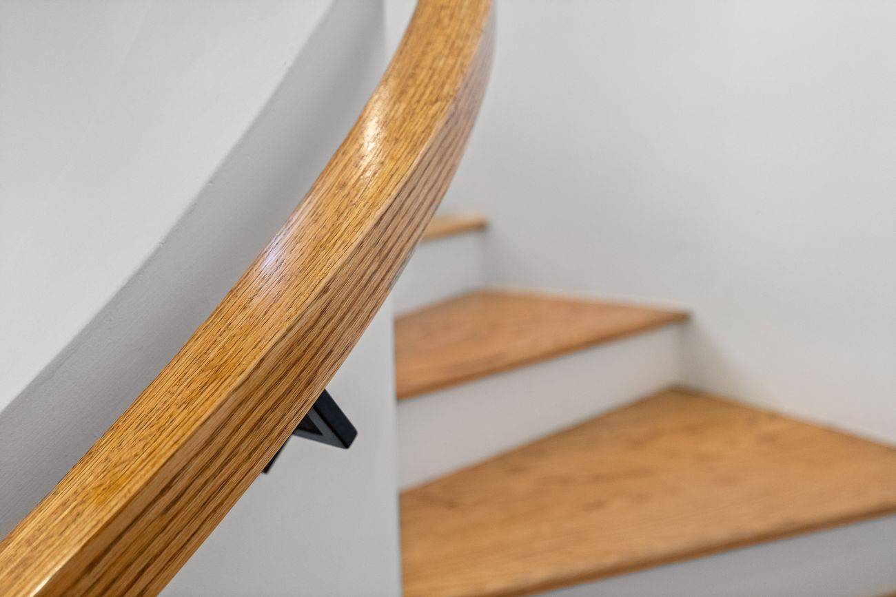 Gaudí-inspired curved staircase with sweeping plaster walls