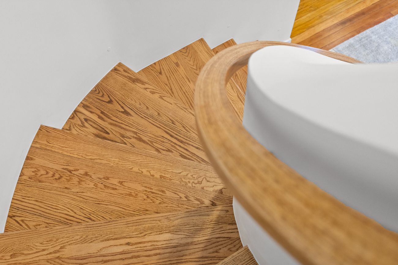 Sculptural staircase rising through the restored home