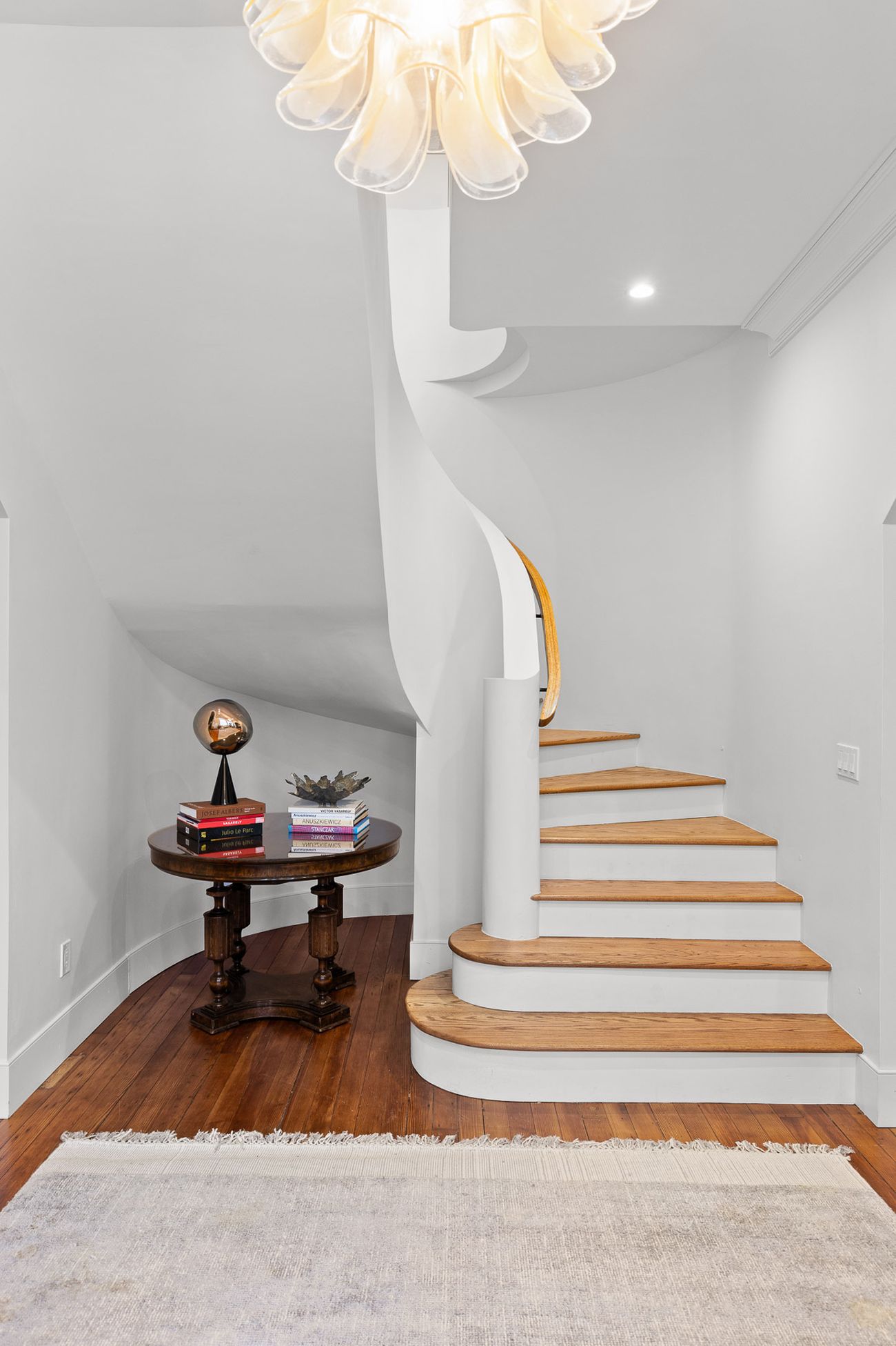 Custom curved staircase detail in oak and plaster