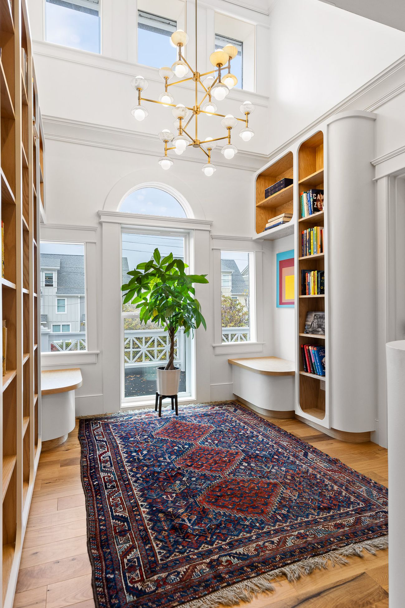 Floor-to-ceiling custom bookshelves with rolling ladder