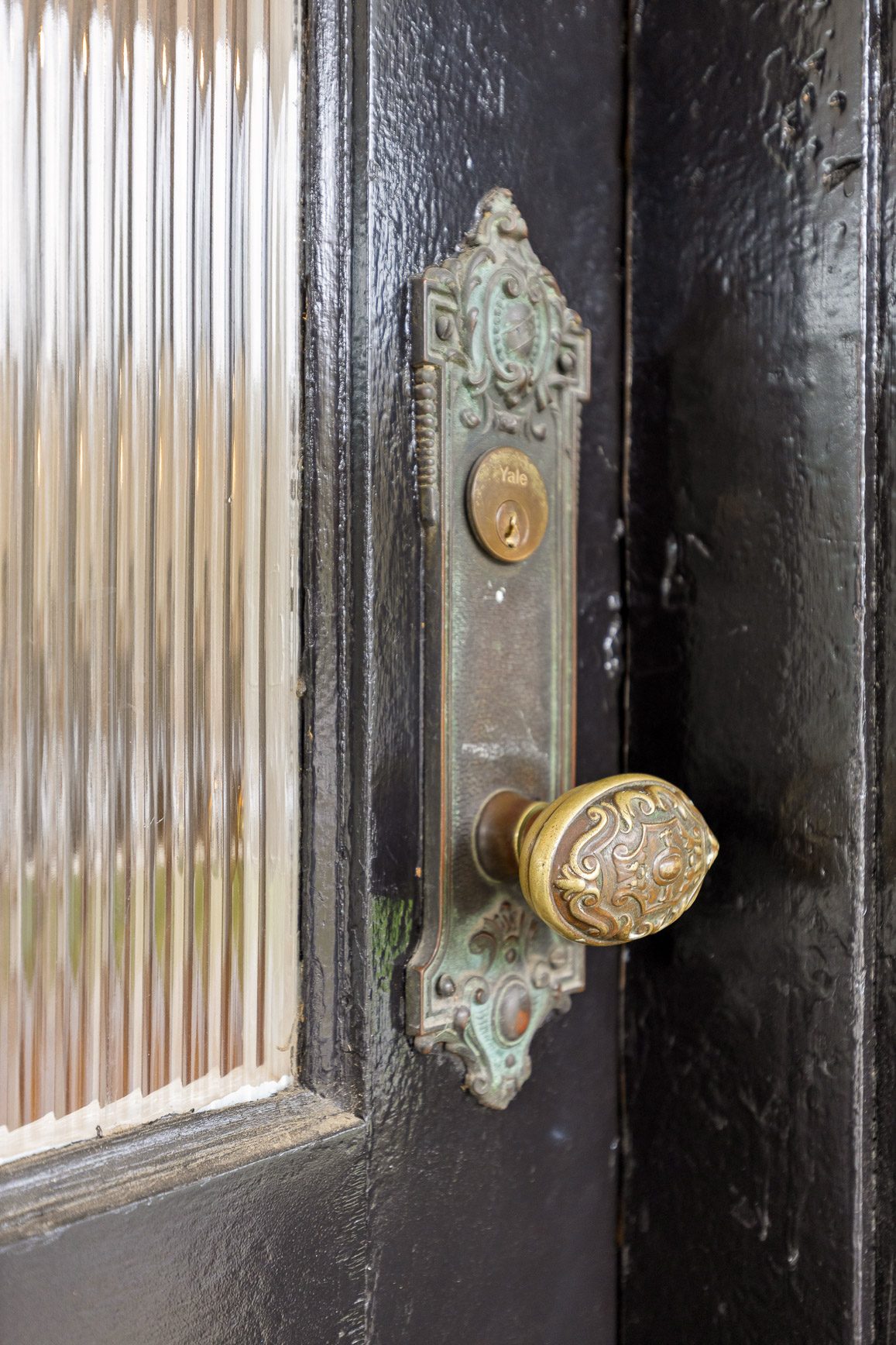 Original brass door hardware and reeded glass, cleaned and returned to use