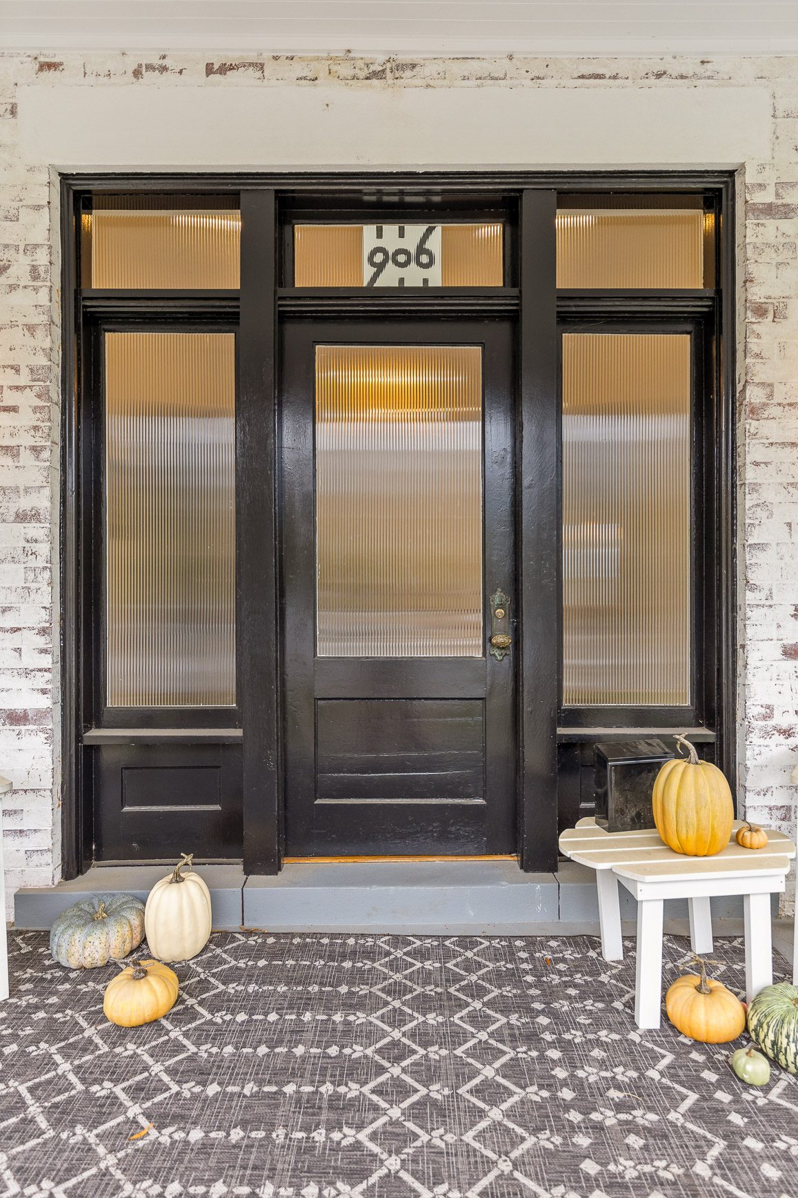 Restored period front door with original transom glazing and brass hardware