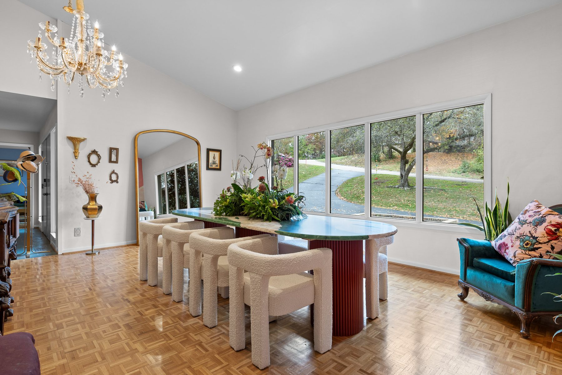 Vaulted great room with a sculptural plaster table and arched river-view windows