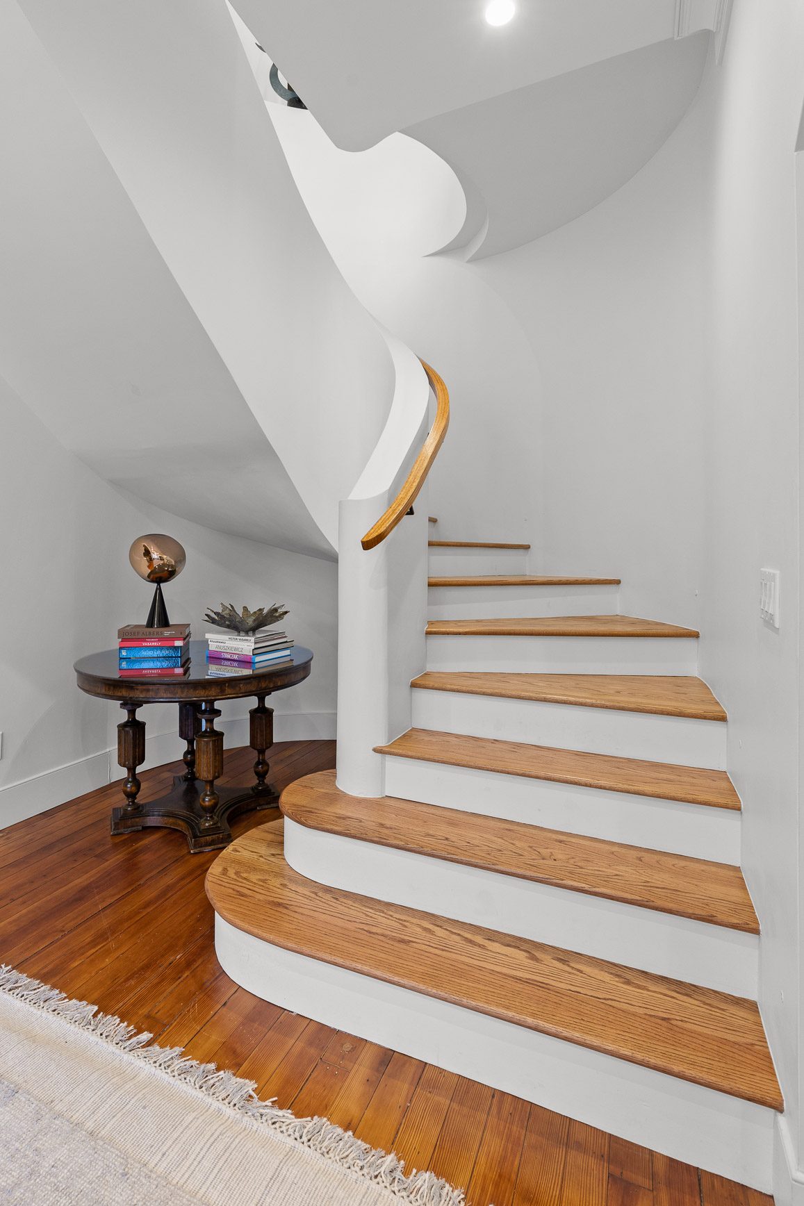 Hand-shaped oak handrail on a restored curved staircase